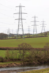 Electricity pylons crossing the agricultural landscape of north Devon UK
