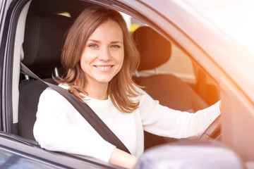 Young attractive woman driving his car