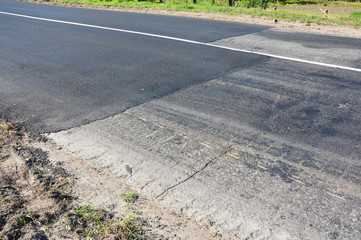 Close up on asphalt road repair. Laying new asphalt road.