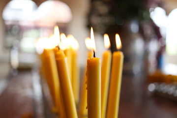 Candles light of burning at temple in abstract candles backgroun