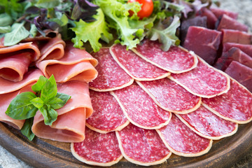 Antipasto with ham, salami and bresaola. tomato and basil. selec