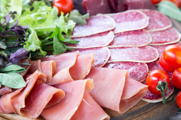Antipasto with ham, salami and bresaola. tomato and basil. selec