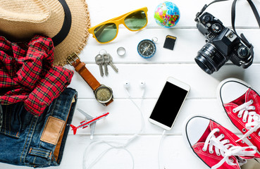 Travel Clothing accessories Apparel for the trip on white wood