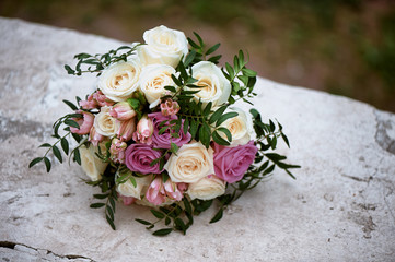 Bridal bouquet of cream and pink roses. Wedding floristry