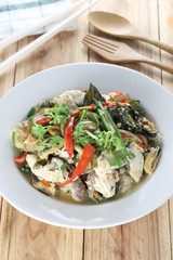 White sea bass puff a herbs in spicy Thai foods in white plate.