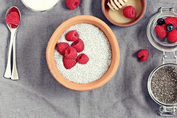 Overnight chia seeds pudding with fresh raspberries. Healthy breakfast to go. Superfoods concept 