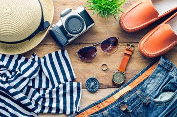 Tourism planning and equipment needed for the trip on wooden floor