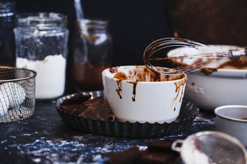 Chocolate cupcake ingredients on a dark kitchen table.
