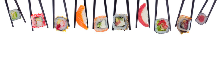 A lot of sushi and rolls in black chopsticks isolated on white background