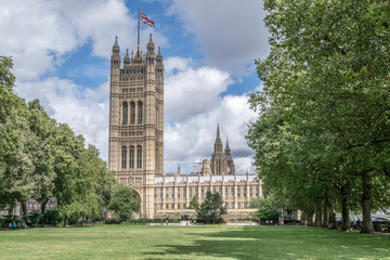 Obraz premium Westminster Palace, London, UK. View from the Victoria Tower Gardens with blue sky and clouds