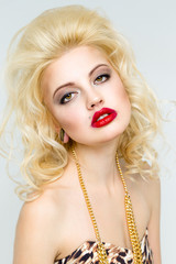 Beautiful young woman with makeup and red lips . Glamour style. Sensual Posing