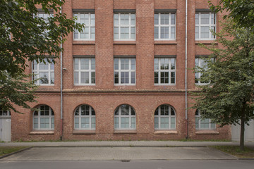 Fototapeta na wymiar red brick building facade and sidewalk
