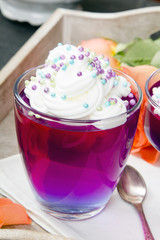 Colorful jelly with whipped cream and candy topping