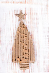 Christmas background with cardboard christmas tree on wooden background