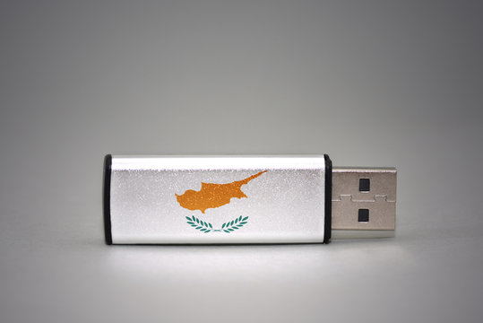 usb flash drive with the national flag of cyprus on gray background.