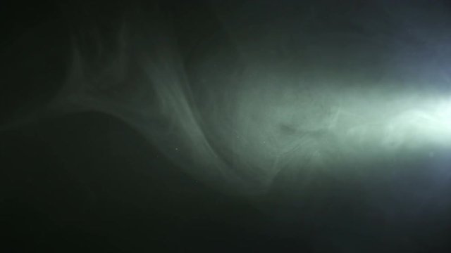 2 in 1! The stream of thick smoke on a dark background. Slow motion capture