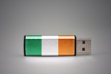 usb flash drive with the national flag of ireland on gray background.