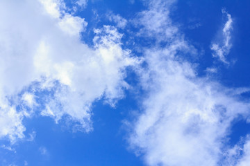 Blue sky background with white clouds. The vast blue sky and clouds sky on sunny day. White fluffy clouds in the blue sky.