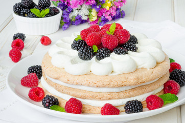 Layer walnut cake with cream and berries