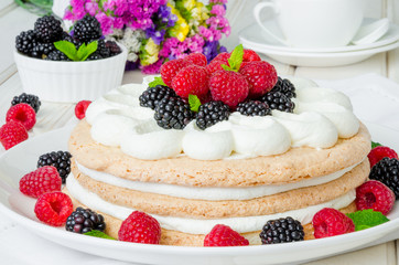 Layer walnut cake with cream and berries