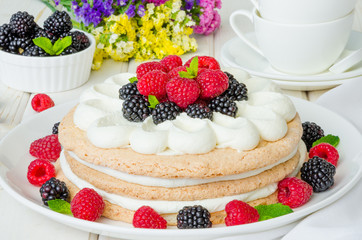 Layer walnut cake with cream and berries