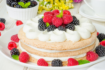 Layer walnut cake with cream and berries