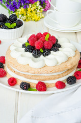 Layer walnut cake with cream and berries