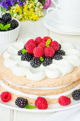Layer walnut cake with cream and berries