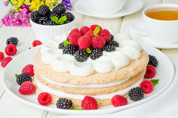 Layer walnut cake with cream and berries