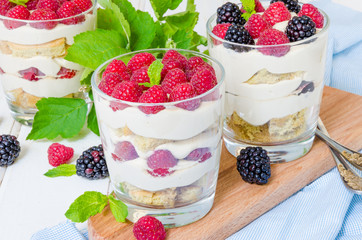 Tiramisu in a glass with coffee sponge cake and fresh berries