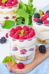Tiramisu in a glass with coffee sponge cake and fresh berries