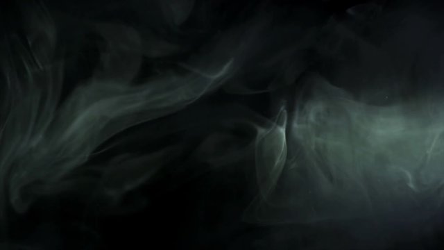 3 in ! The stream of thick smoke on a dark background. Slow motion capture