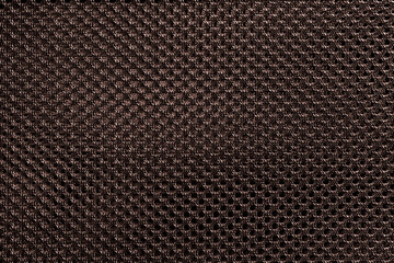 Brown fishnet cloth material as a texture background. Nylon texture pattern or nylon background for design with copy space for text or image.