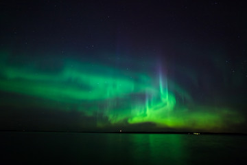 Northern lights over lake in finland