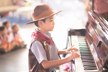 Little boy playing piano outdoor performance