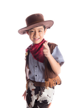 Little boy in cowboy costume on white background