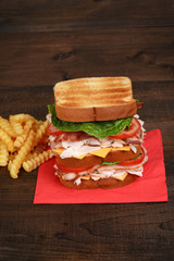 turkey club sandwich on red napkin