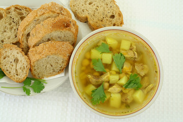 soup of chickpeas and sliced bread on white plates