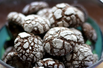 Chocolate crackle cookies in a bowl. Decorated with granulated and powdered sugar. Selective focus.