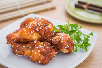Fried spicy chicken with sesame seeds on plate