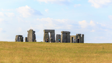 WILTSHIRE,UNITED KINGDOM, JULY 9, 2014  :   People visiting Stonehenge on the lush countryside of England in Wiltshire.