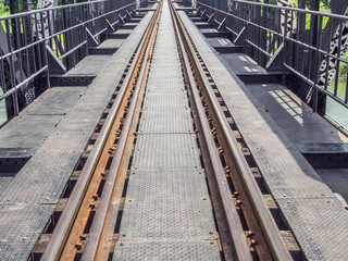 Fototapeta premium Closeup of an old railway track on steel bridge