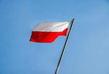 Poland flag fluttering on a metal flagpole 