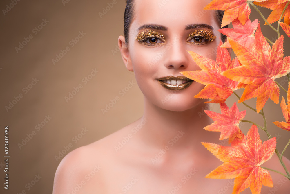 Wall mural young woman with dry autumn leaves