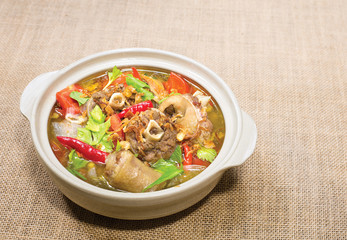 Oxtail soup in white dish on brown tablecloth/ Halal food