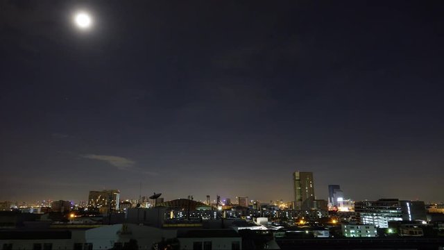 Timelapse of The moon trails above city in Bangkok Thailand