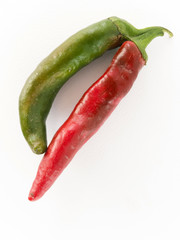 Red and green chili peppers on white background