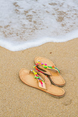 Fototapeta na wymiar Summer flip flops on the beach