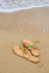 Fototapeta na wymiar Summer flip flops on the beach