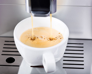 coffee machine makes cup of coffee